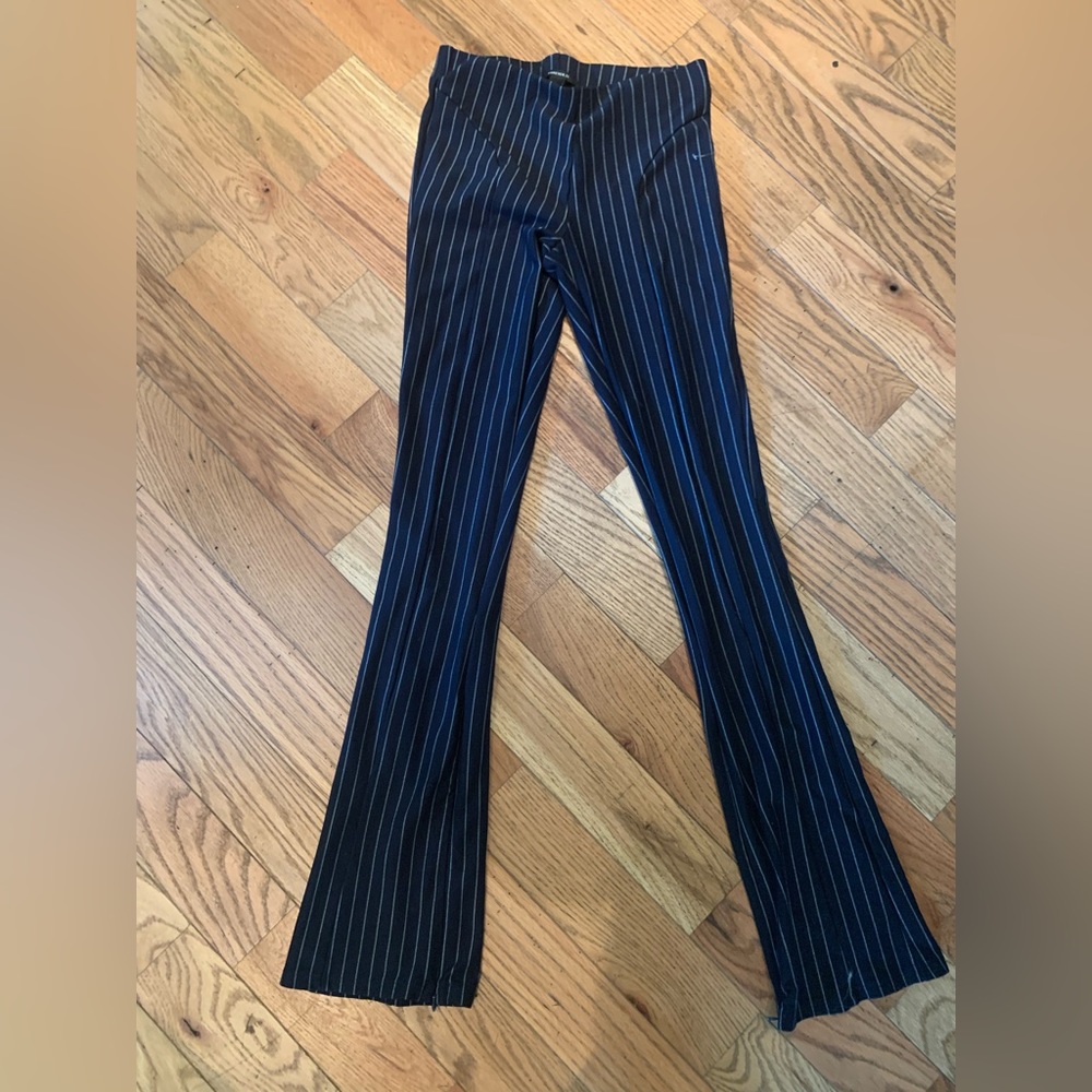 Pinstriped flare leggings with zipper detail on ankles.